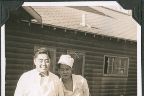 Two men in cook's uniforms outside building (ddr-ajah-2-550)