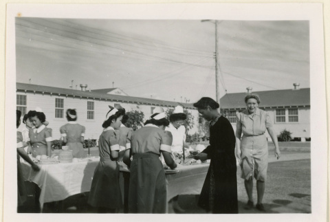 Serving tea at a hospital tea party (ddr-densho-37-1253)