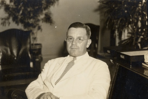 Man seated in an office (ddr-njpa-2-414)