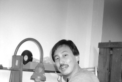 Man with film reels (ddr-densho-1007-556)