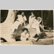 Three women sitting on log (ddr-densho-523-37)