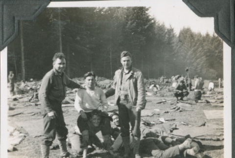 Group of men joking around by camp equipment (ddr-ajah-2-235)