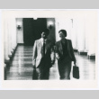 Man and woman walking through a hall (ddr-densho-1007-393)