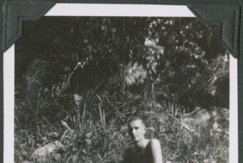 Man sitting on rock in swim trunks (ddr-ajah-2-638)