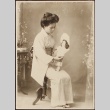 Portrait of Japanese woman in kimono with doll (ddr-densho-259-64)
