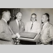 Four men looking at the Johnson Hall dedication plaque (ddr-njpa-2-1026)