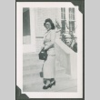 A woman standing on front steps (ddr-densho-328-239)