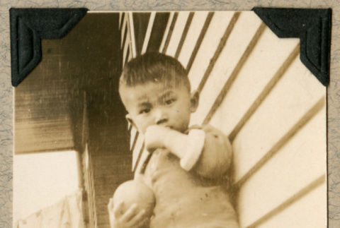 Kiyotaka Fukuhara as young boy with ball on porch (ddr-densho-383-38)