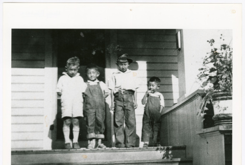 Four children on porch (ddr-densho-1007-226)