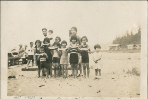 Children eating watermelon on the beach (ddr-densho-321-630)