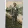 Man standing alongside river (ddr-densho-523-4)