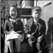 Masako and Norman Takahashi sitting on steps (ddr-densho-426-930)