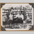 Gary Kikawa behind a shop counter (ddr-densho-542-65)