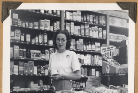 Woman poses with a product (ddr-densho-542-117)