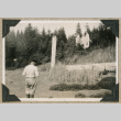 Man in front of totem pole and Russian Church (ddr-densho-383-321)