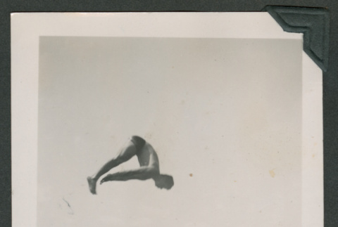 Photo of a man performing a toe touch dive (ddr-densho-483-376)