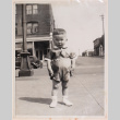 Photo of a baby standing on a city street (ddr-densho-483-412)