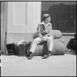 Japanese American waiting with baggage (ddr-densho-151-102)