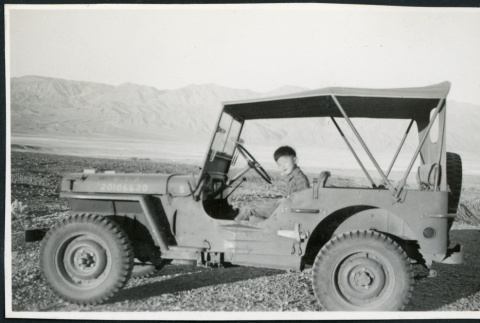 Photograph of a young boy sitting in an Army jeep in Death Valley (ddr-csujad-47-134)