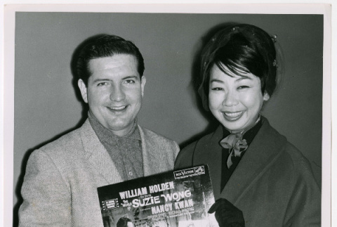Mary Mon Toy with man holding album soundtrack for The World of Suzie Wong film (ddr-densho-367-194)