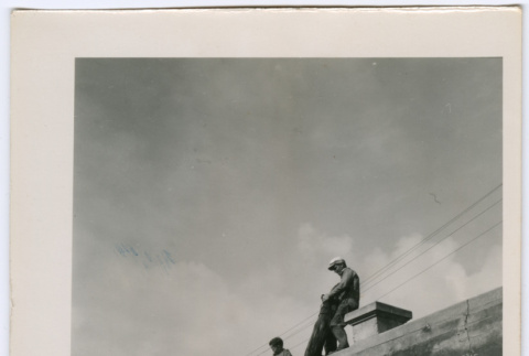 Lowering log over a wall (ddr-densho-377-1611)