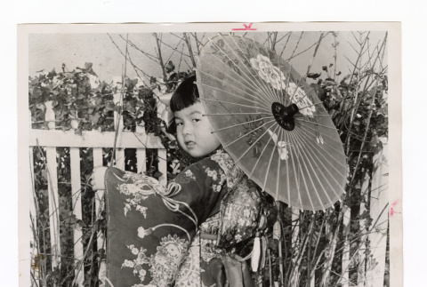 Vicki Ikeguchi, 4 years old, wearing kimono and twirling a parasol (ddr-csujad-52-8)