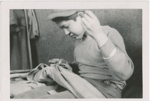 A boy sewing pants (ddr-densho-273-8)