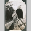 Man standing by entrance to tunnel (ddr-ajah-2-321)