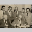 Ingram Stainback signing a document while other men look on (ddr-njpa-2-1195)