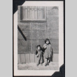 Two children standing outside barracks (ddr-densho-467-14)