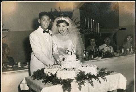 Bride and groom cut their wedding cake (ddr-densho-395-13)