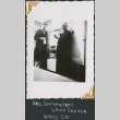 Two men standing by refrigerator (ddr-densho-434-152)