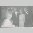 Bride and groom cutting cake with groom's parents Agnes and Chester Sakura (ddr-densho-523-350)