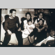 Three adults on couch with children (ddr-densho-1007-624)