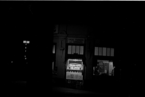 Nighttime photo of Golden Poppy Ice Cream Shop (ddr-densho-426-1827)
