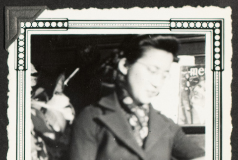 Mit seated and reading a book (ddr-densho-542-374)
