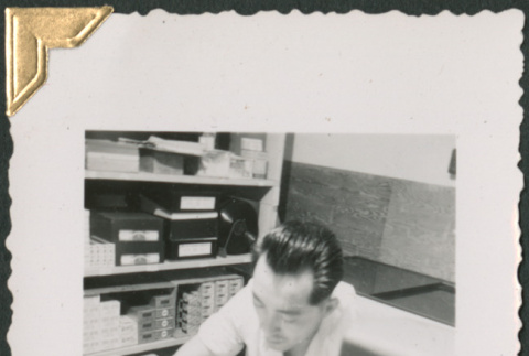 Man sitting at desk (ddr-densho-434-150)