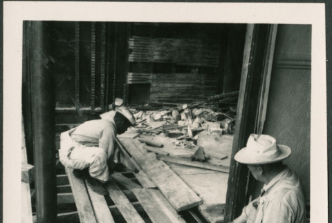 Two men laying flooring (ddr-densho-426-2275)