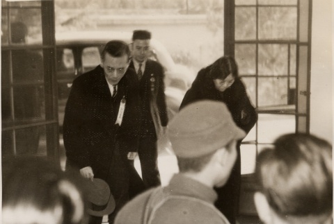 A man and woman bowing when entering a building (ddr-njpa-1-1030)