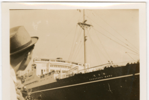 Man looking out over water toward ship (ddr-densho-426-1682)