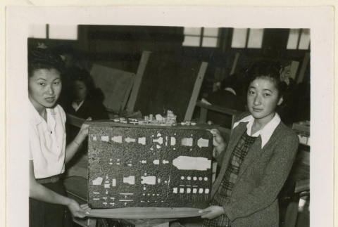 Girls hold up ship model parts (ddr-densho-37-1242)