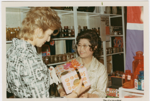 Tomoye Takahashi with unknown woman by product display (ddr-densho-426-1092)