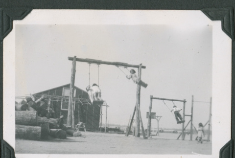 Children playing on swings (ddr-densho-471-29)