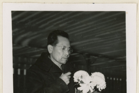 Mr. Nakata holding chrysanthemums (ddr-densho-37-1195)