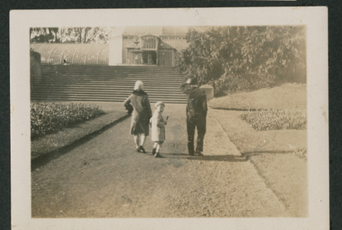 two adults and a child walking toward a building (ddr-densho-378-808)