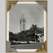 Clock tower rises above a tree lined street (ddr-densho-404-253)