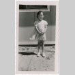 Girl standing outside barracks (ddr-densho-329-1320)