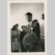 Man holding a coat (ddr-densho-37-1201)