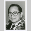 Portrait of person with glasses and lei (ddr-densho-1007-74)