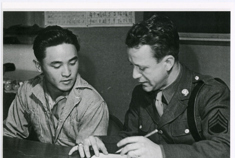 Nisei man signing enlistment papers (ddr-densho-122-757)